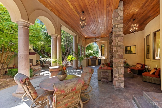 view of patio with exterior kitchen, a ceiling fan, an outdoor living space with a fireplace, and outdoor dining space