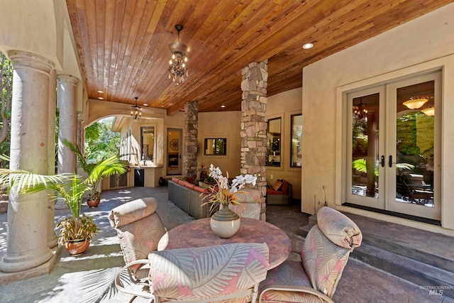 dining room with decorative columns, french doors, wood ceiling, carpet, and recessed lighting