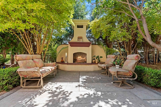 view of patio / terrace with a warm lit fireplace