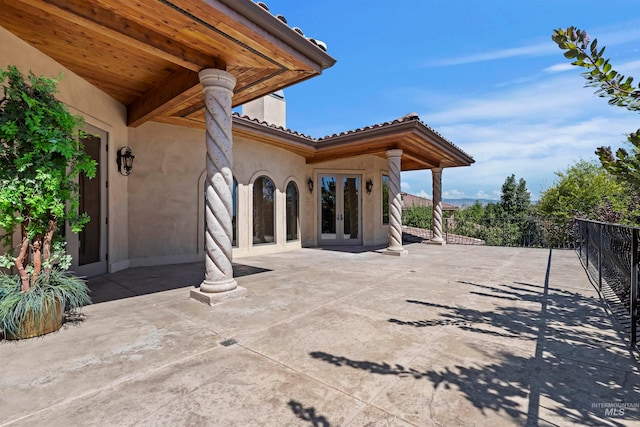 view of patio / terrace featuring french doors and fence