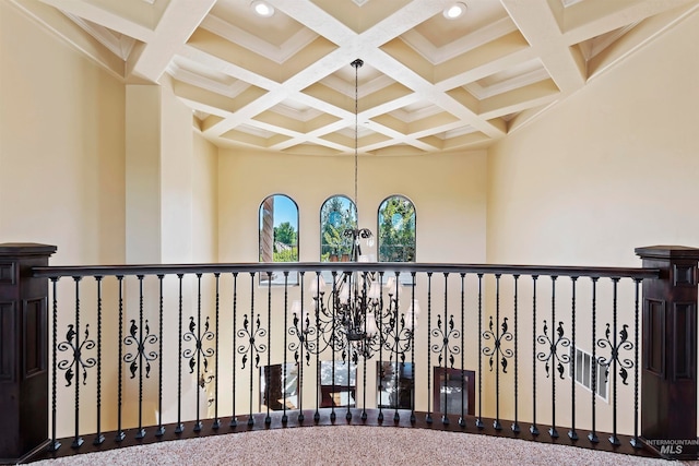 corridor featuring coffered ceiling, beamed ceiling, crown molding, and recessed lighting