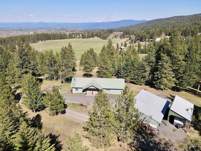 drone / aerial view featuring a forest view and a mountain view