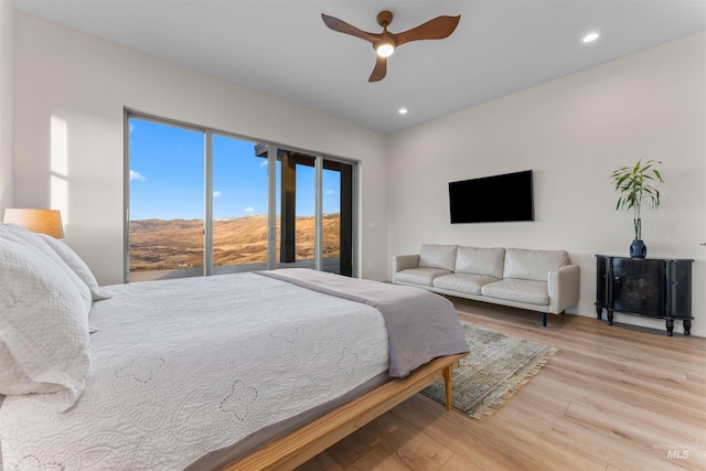 bedroom with ceiling fan, wood finished floors, and recessed lighting