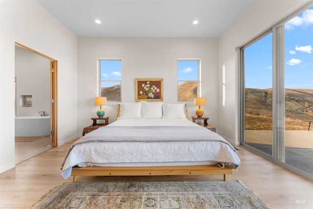 bedroom with light wood-style floors, access to outside, baseboards, and recessed lighting