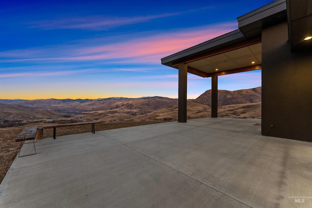 patio terrace at dusk with a mountain view