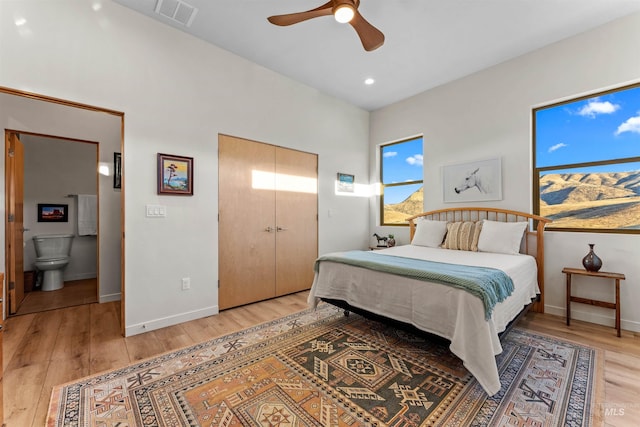 bedroom with light wood finished floors, baseboards, and visible vents