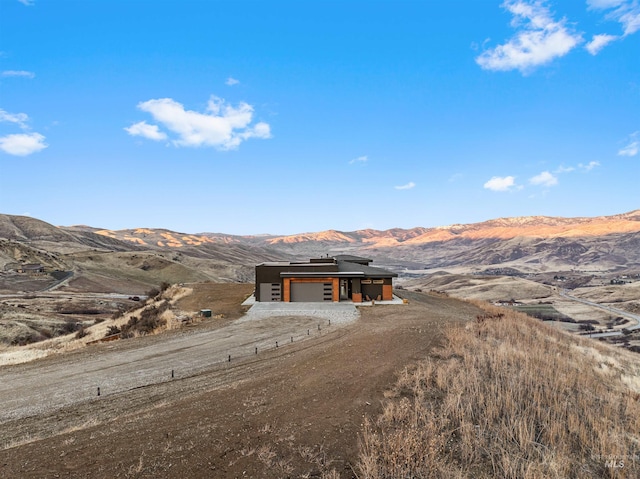 view of front of home with an attached garage and a mountain view