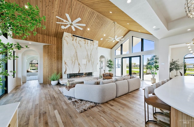 680 N Delehaye Ave, Eagle, ID 83616 - living area featuring arched walkways, high vaulted ceiling, ceiling fan with notable chandelier, light wood-style floors, and recessed lighting
