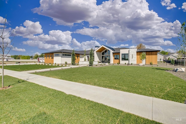 680 N Delehaye Ave, Eagle, ID 83616 - view of front facade with fence, stone siding, and a front lawn