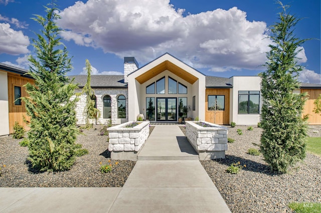 680 N Delehaye Ave, Eagle, ID 83616 - back of property with french doors, a chimney, a shingled roof, and stone siding