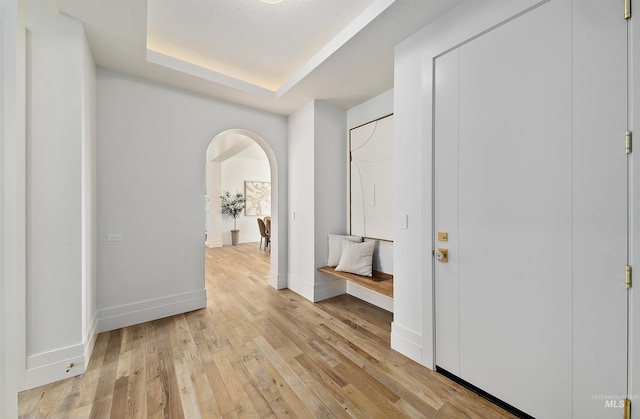 680 N Delehaye Ave, Eagle, ID 83616 - corridor featuring arched walkways, baseboards, a raised ceiling, and light wood-type flooring