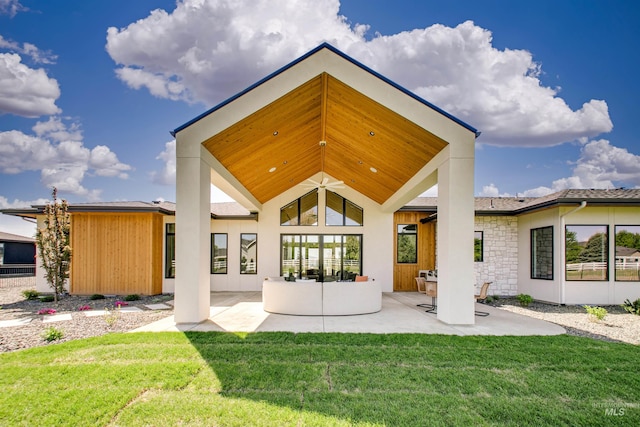 680 N Delehaye Ave, Eagle, ID 83616 - rear view of property with a patio, a lawn, stucco siding, and stone siding