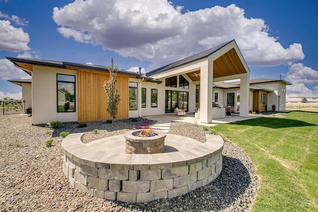 680 N Delehaye Ave, Eagle, ID 83616 - rear view of house with fence, a patio, a ceiling fan, a lawn, and an outdoor fire pit