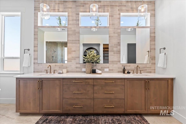 3436 N Mayberry Way, Eagle, ID 83616 - bathroom featuring baseboards, a sink, backsplash, and double vanity