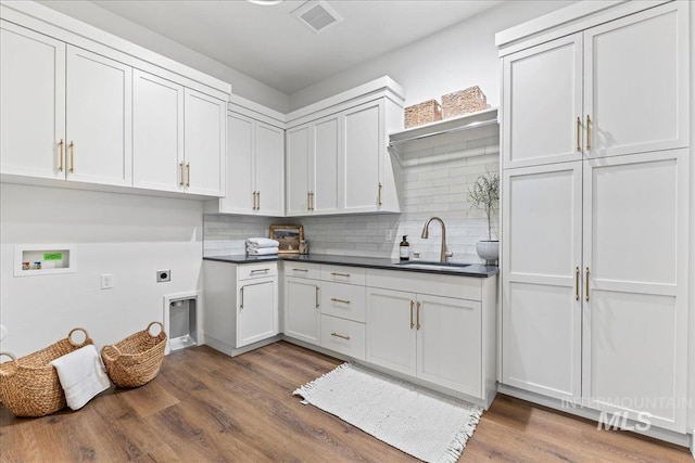 3436 N Mayberry Way, Eagle, ID 83616 - kitchen featuring a sink, dark countertops, and decorative backsplash