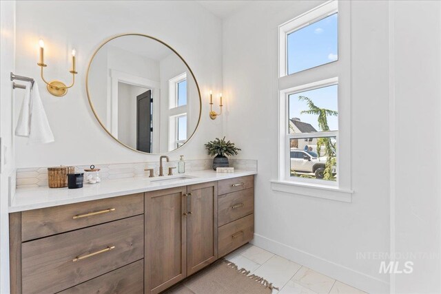 3436 N Mayberry Way, Eagle, ID 83616 - bathroom featuring vanity, marble finish floor, baseboards, and a wealth of natural light