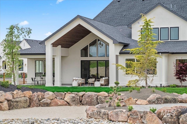 3436 N Mayberry Way, Eagle, ID 83616 - back of property with a patio area, roof with shingles, and stucco siding