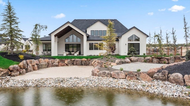 3436 N Mayberry Way, Eagle, ID 83616 - rear view of property featuring a water view, a patio area, and stucco siding