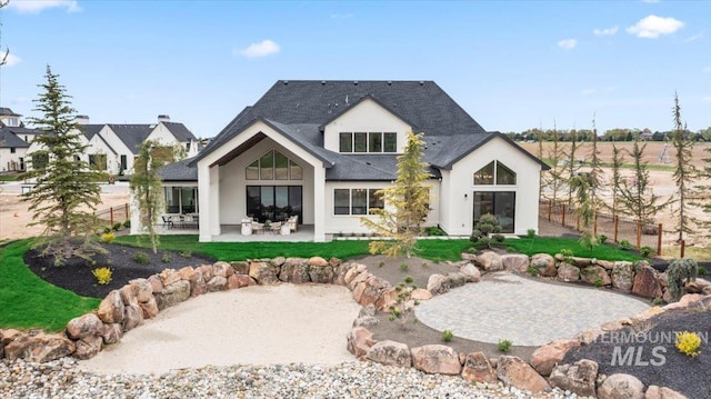 3436 N Mayberry Way, Eagle, ID 83616 - back of property featuring fence, stucco siding, a patio area, and roof with shingles