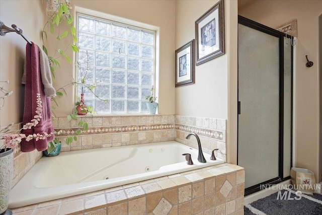 full bathroom with a shower stall and a jetted tub