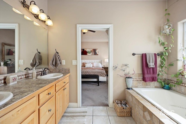 bathroom with tile patterned flooring, connected bathroom, a garden tub, double vanity, and a sink