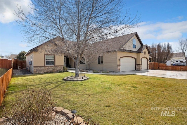 view of front facade featuring fence, driveway, stucco siding, a front lawn, and stone siding