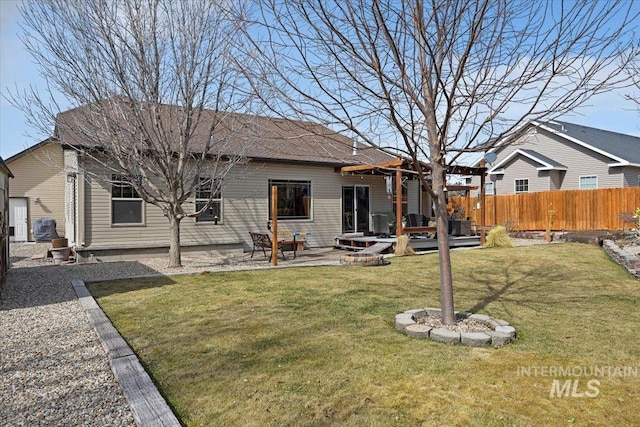 back of house with a patio, a yard, and fence