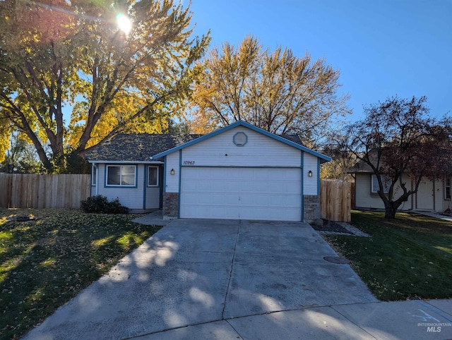 single story home featuring a garage and a front lawn