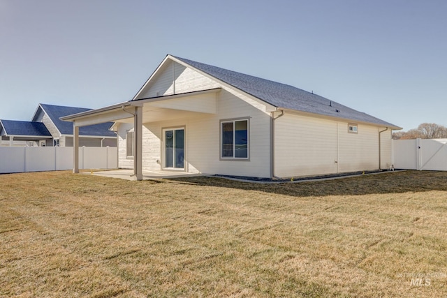 back of property with a patio and a lawn