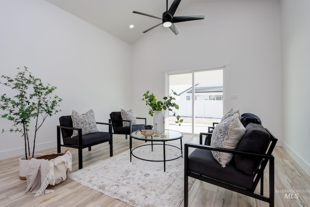 sitting room featuring ceiling fan, light hardwood / wood-style floors, and high vaulted ceiling