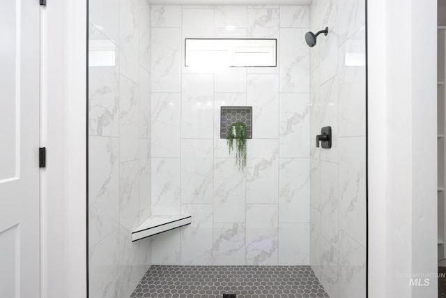 bathroom with tiled shower