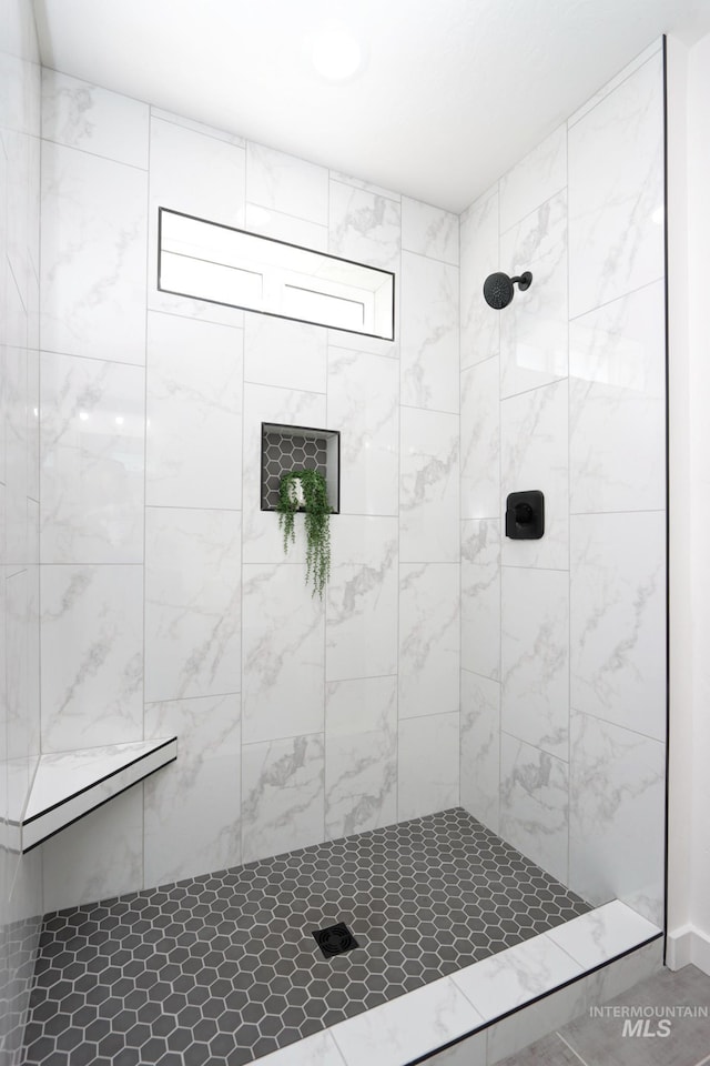 bathroom with tiled shower