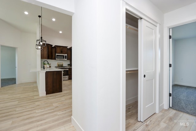 hall featuring sink and light wood-type flooring