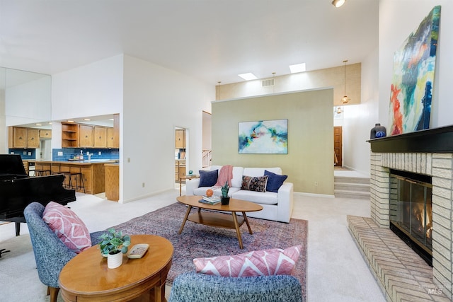 1574 E Sendero Ln, Boise, ID 83712 - living room with light carpet, a brick fireplace, baseboards, and a high ceiling