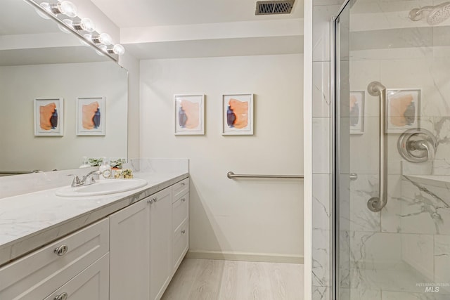 1574 E Sendero Ln, Boise, ID 83712 - bathroom with a stall shower, vanity, baseboards, and wood finished floors