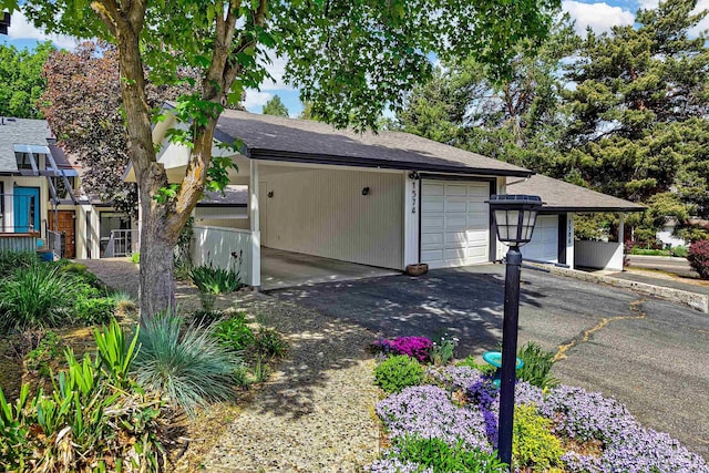 1574 E Sendero Ln, Boise, ID 83712 - garage with asphalt driveway and a carport