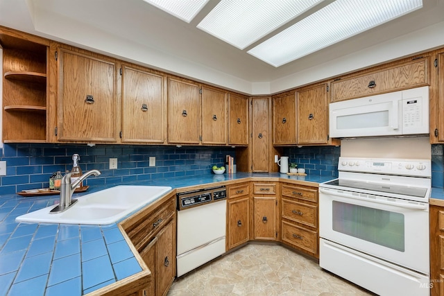 1574 E Sendero Ln, Boise, ID 83712 - kitchen with white appliances, a sink, brown cabinets, decorative backsplash, and tile counters