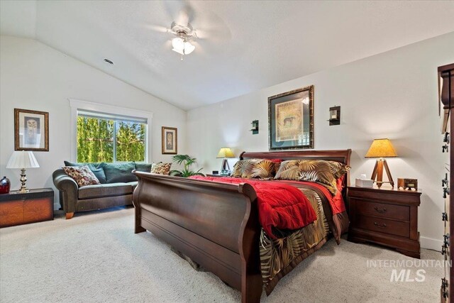 bedroom featuring carpet floors, a ceiling fan, and lofted ceiling