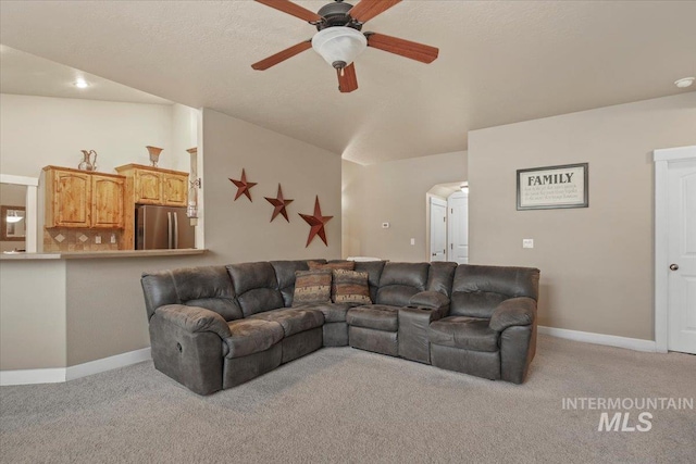 carpeted living room with ceiling fan