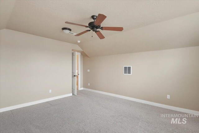 bonus room featuring carpet flooring, ceiling fan, a textured ceiling, and vaulted ceiling