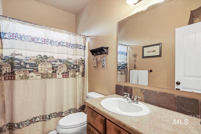 bathroom with a shower with curtain, vanity, and toilet