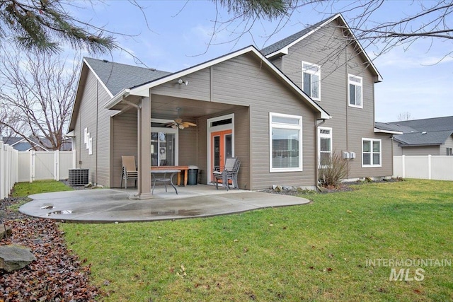 back of property with a lawn, ceiling fan, central air condition unit, and a patio