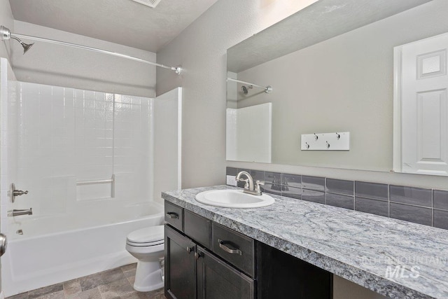 full bathroom featuring bathtub / shower combination, vanity, tasteful backsplash, and toilet