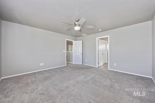 unfurnished bedroom with ceiling fan, carpet floors, and a textured ceiling