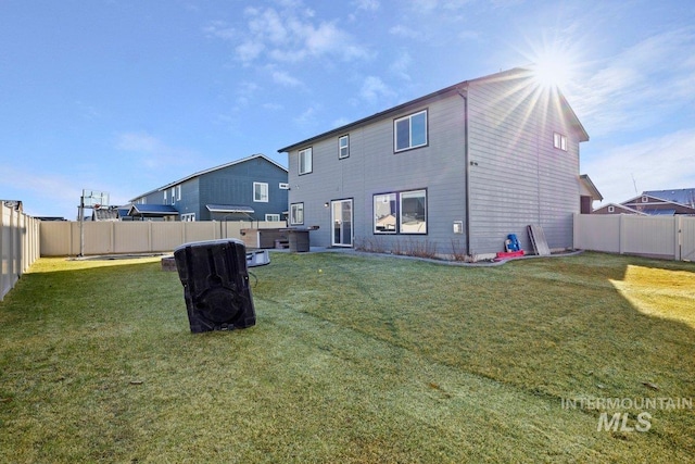 rear view of house with a yard