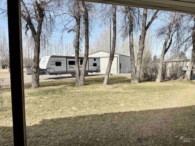 view of yard with an outbuilding, an outdoor structure, and fence