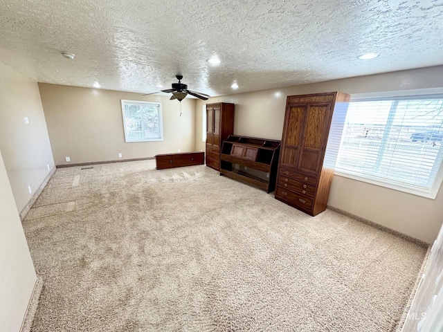 unfurnished living room featuring baseboards, carpet, recessed lighting, a textured ceiling, and a ceiling fan