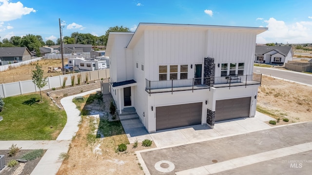 contemporary house featuring a garage and a balcony