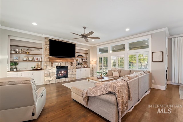 1895 N Rivington Way, Eagle, ID 83616 - living room with crown molding, a stone fireplace, dark wood-style floors, recessed lighting, and a ceiling fan