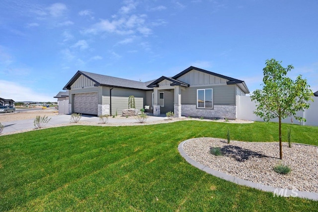 view of front of house with a front yard and a garage